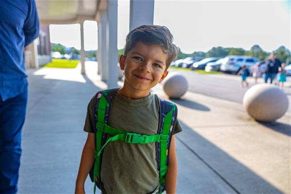 a boy student with his backpack on